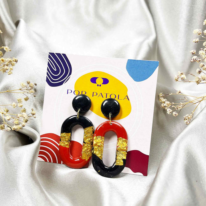 Oval-shaped modern earrings with black top