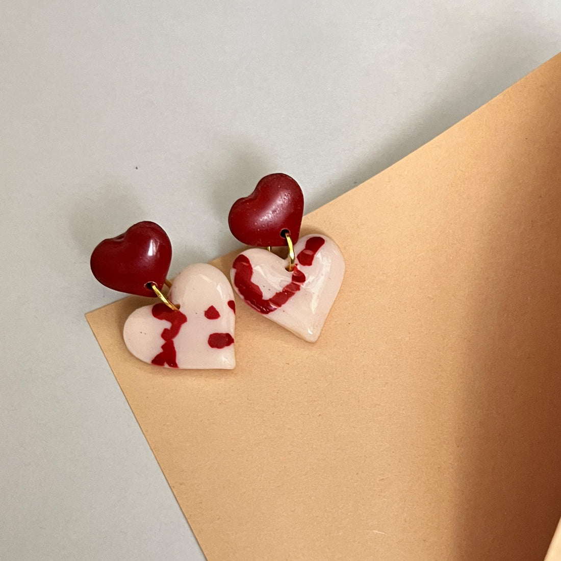 Dangle heart earrings with painterly design