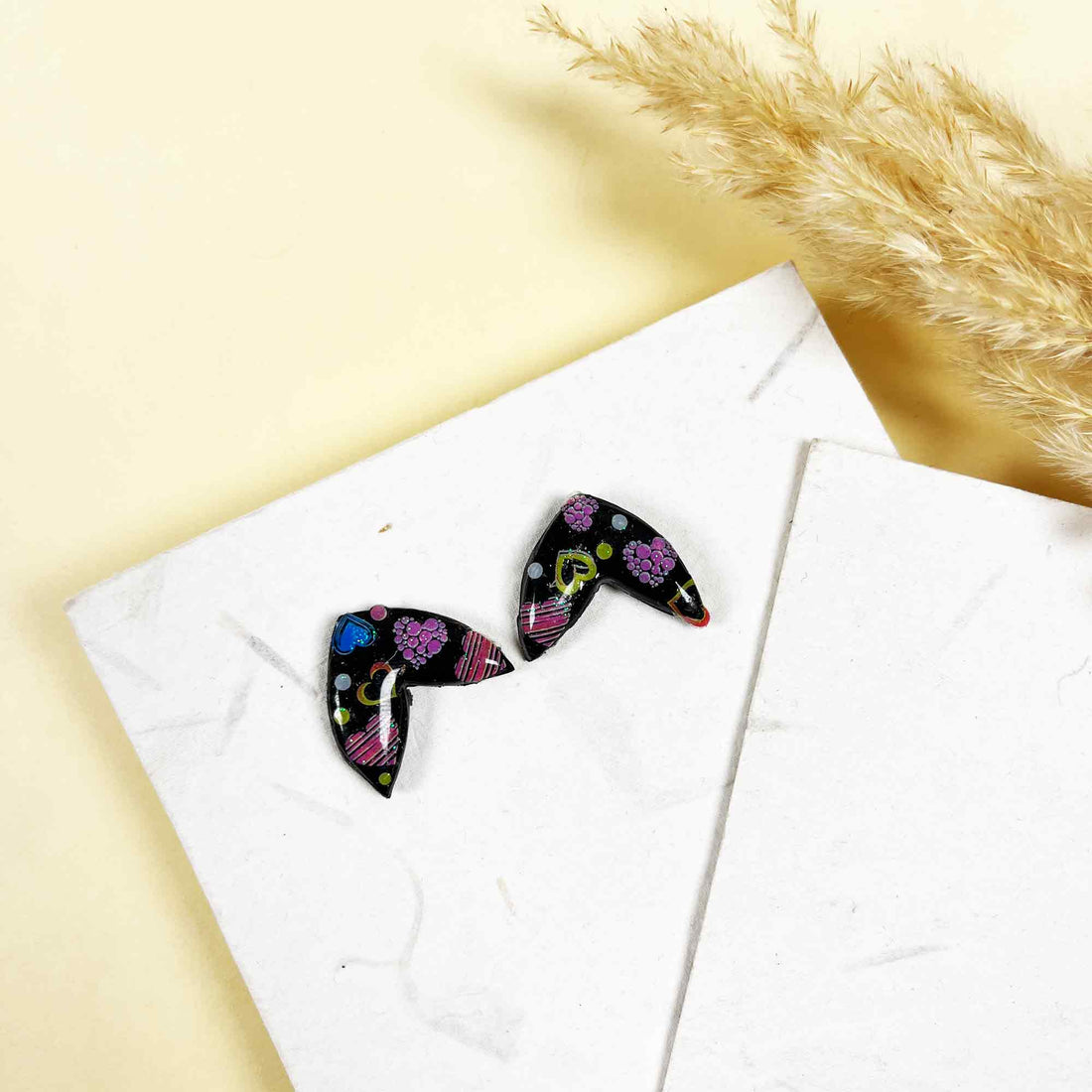 Colorful doodle earrings with floral designs