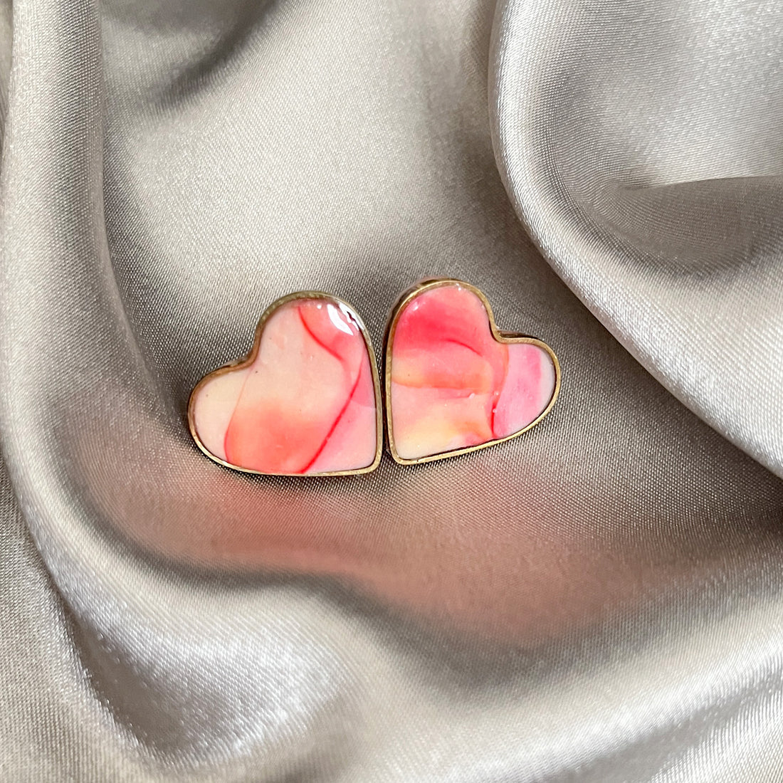 Heart-shaped resin studs in pink and peach
