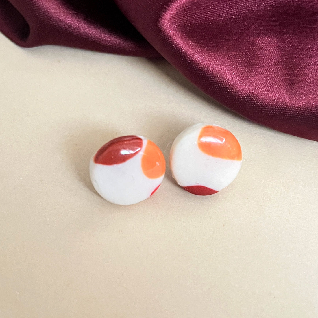 Handmade circle earrings with orange and red accents
