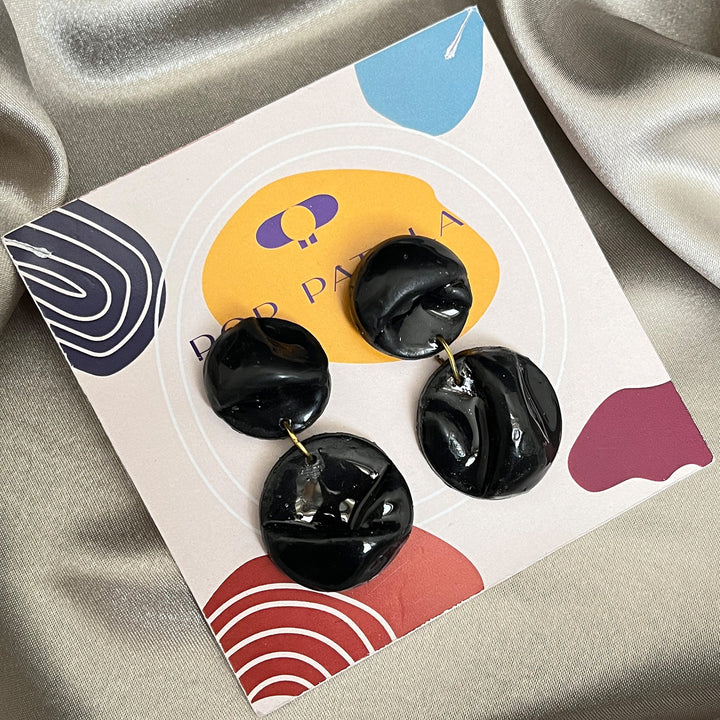 Handmade polymer clay black earrings on Pop Patola card
