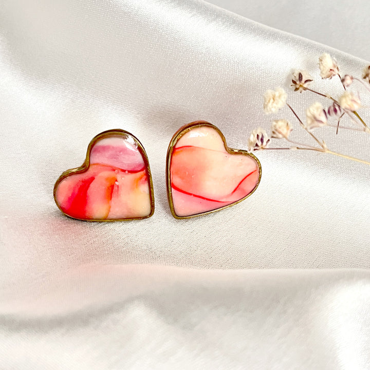 Swirled pink heart earrings in resin finish