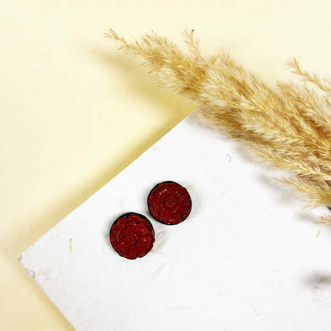 Minimal handmade clay jewelry on satin backdrop