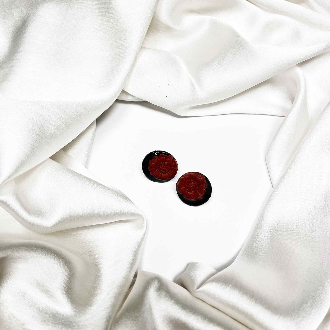 Lightweight clay studs on silk background